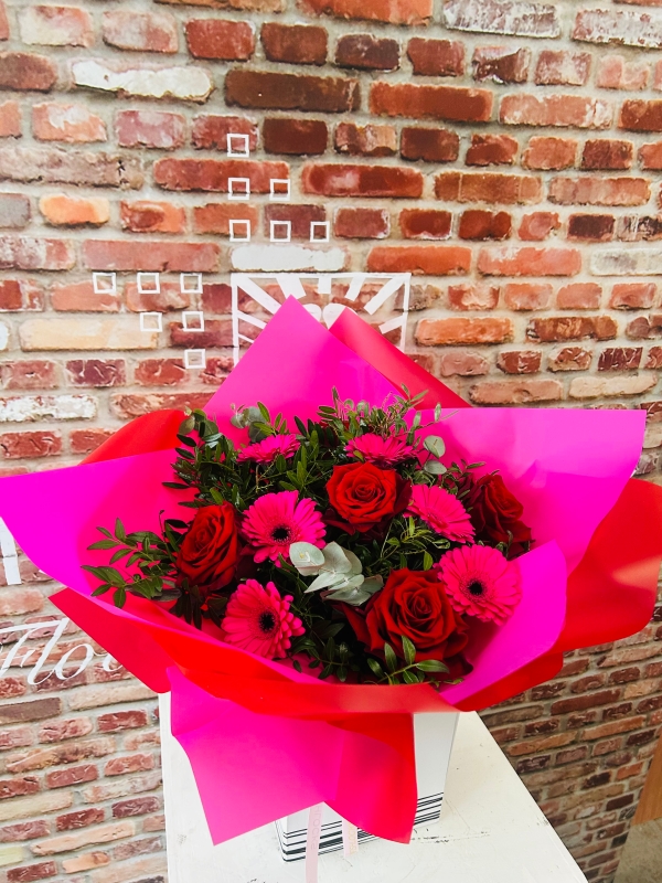  Six scented large headed red Roses with six pink gerbera, bound with foliage