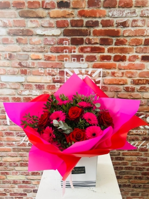  Six scented large headed red Roses with six pink gerbera, bound with foliage
