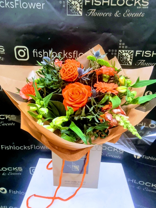 Bouquet of lime green chrysanthemum, shamrock bloom, green hypericum, with orange roses and gerbera