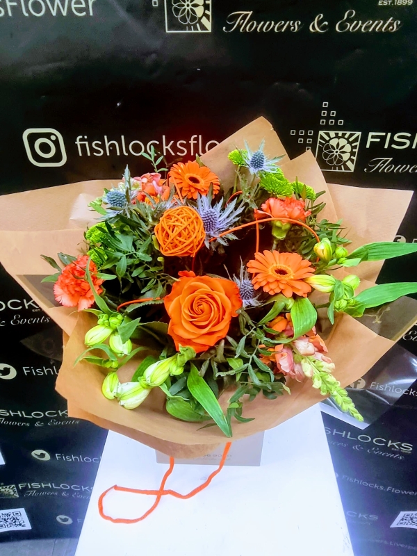 Bouquet of lime green chrysanthemum, shamrock bloom, green hypericum, with orange roses and gerbera