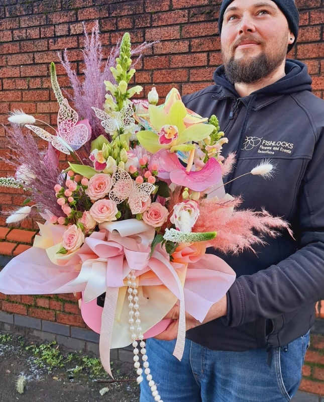 Bouquet of red naomi roses, purple trachelium, viburnum snowball and deep pink Oriental Lilies, mixed with foliage
