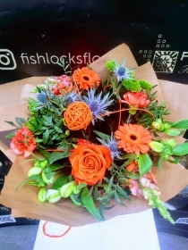 Bouquet of lime green chrysanthemum, shamrock bloom, green hypericum, with orange roses and gerbera